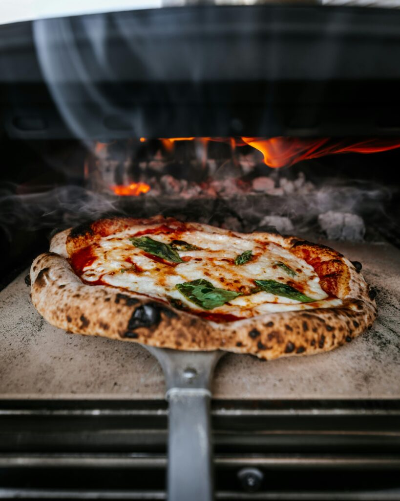 Delicious wood-fired pizza baking in a traditional oven in London.
